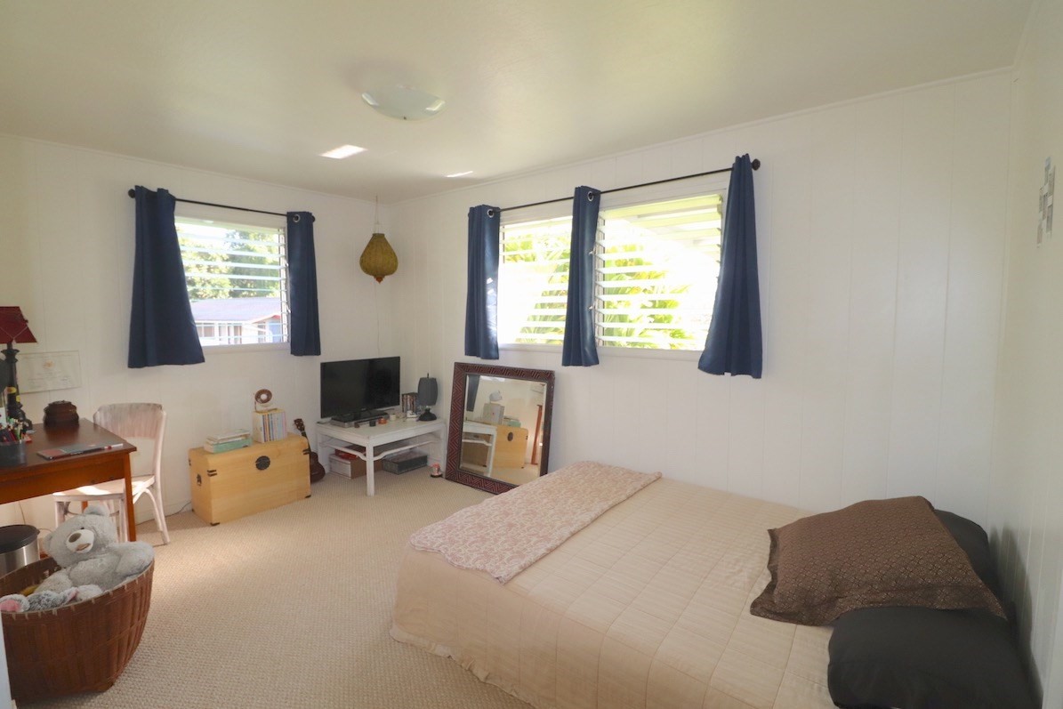 3434 Hailima Road Koloa, HI 96756 - Photo 8 of 13 a bedroom with furniture and a window