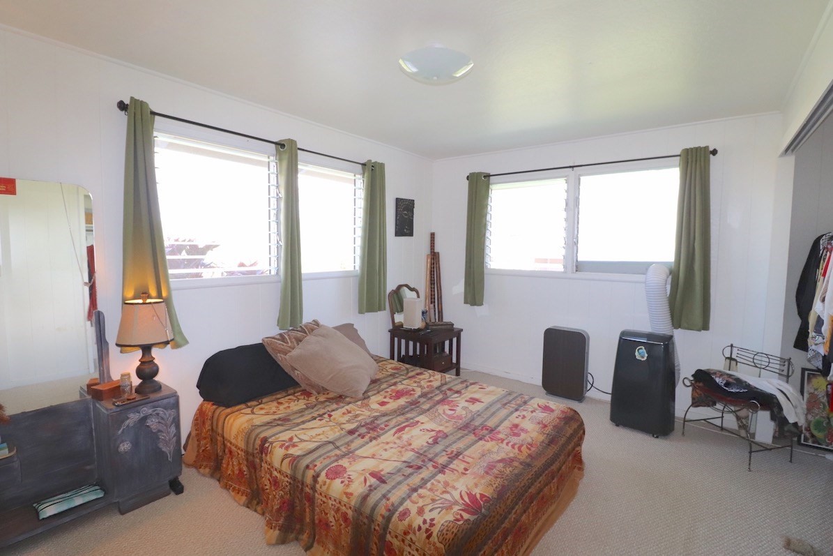 3434 Hailima Road Koloa, HI 96756 - Photo 10 of 13 a bedroom with a bed and a flat tv screen next to a window