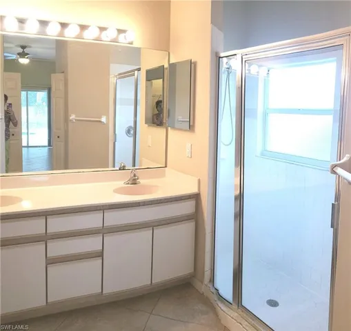 a bathroom with a double vanity sink and a mirror