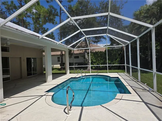 a view of a backyard with table and chairs
