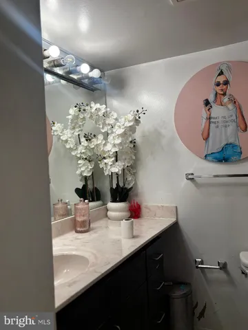 a bathroom with a sink vanity and a mirror
