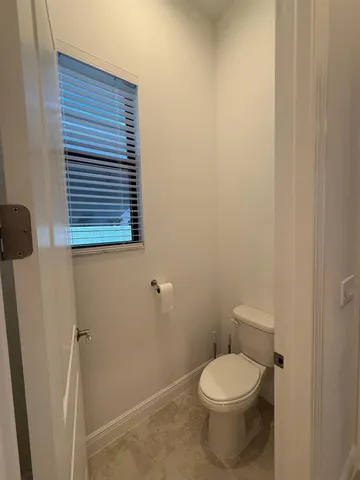 a white toilet sitting next to a small sink