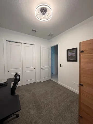 a view of a livingroom with workspace and a window