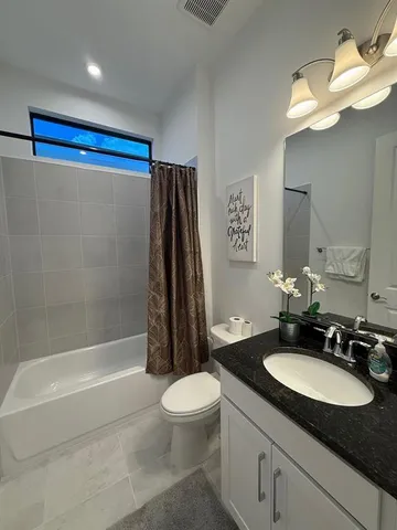 a backyard of a house with a yard and outdoor seating