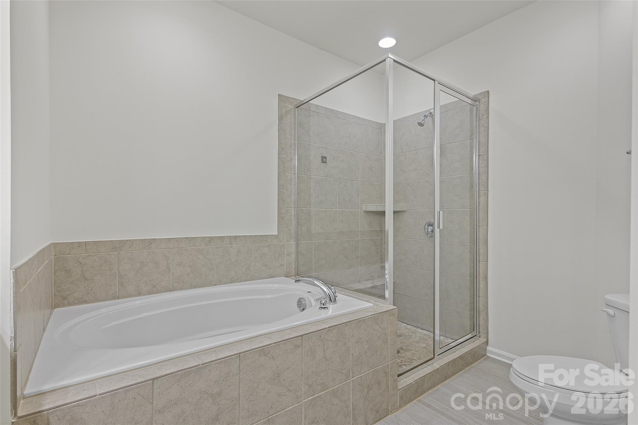 620 Amber Meadows Way Tega Cay, SC 29708 - Photo 16 of 27 a bathroom with a bathtub and a shower