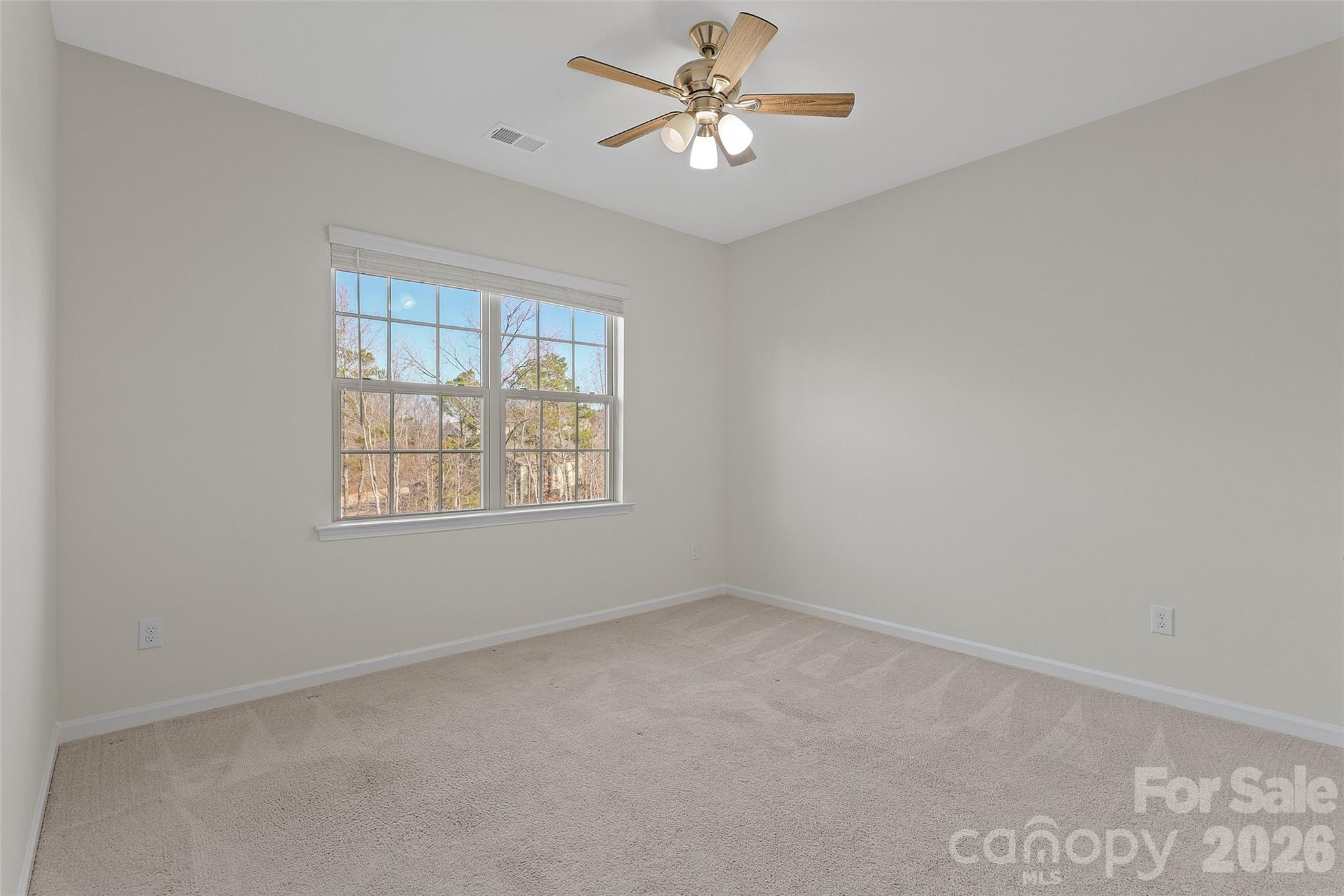 620 Amber Meadows Way Tega Cay, SC 29708 - Photo 18 of 27 an empty room with a window and a fan