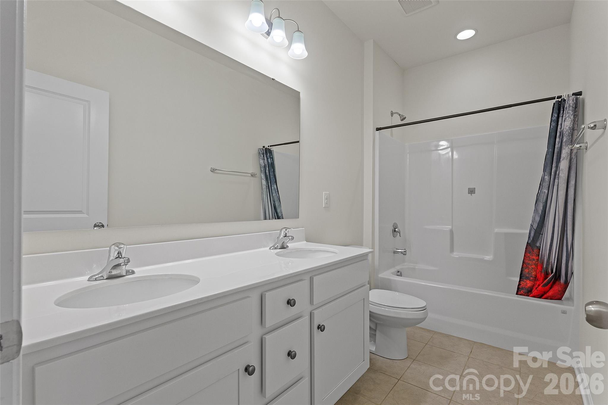 620 Amber Meadows Way Tega Cay, SC 29708 - Photo 19 of 27 a bathroom with a tub sink toilet and a mirror