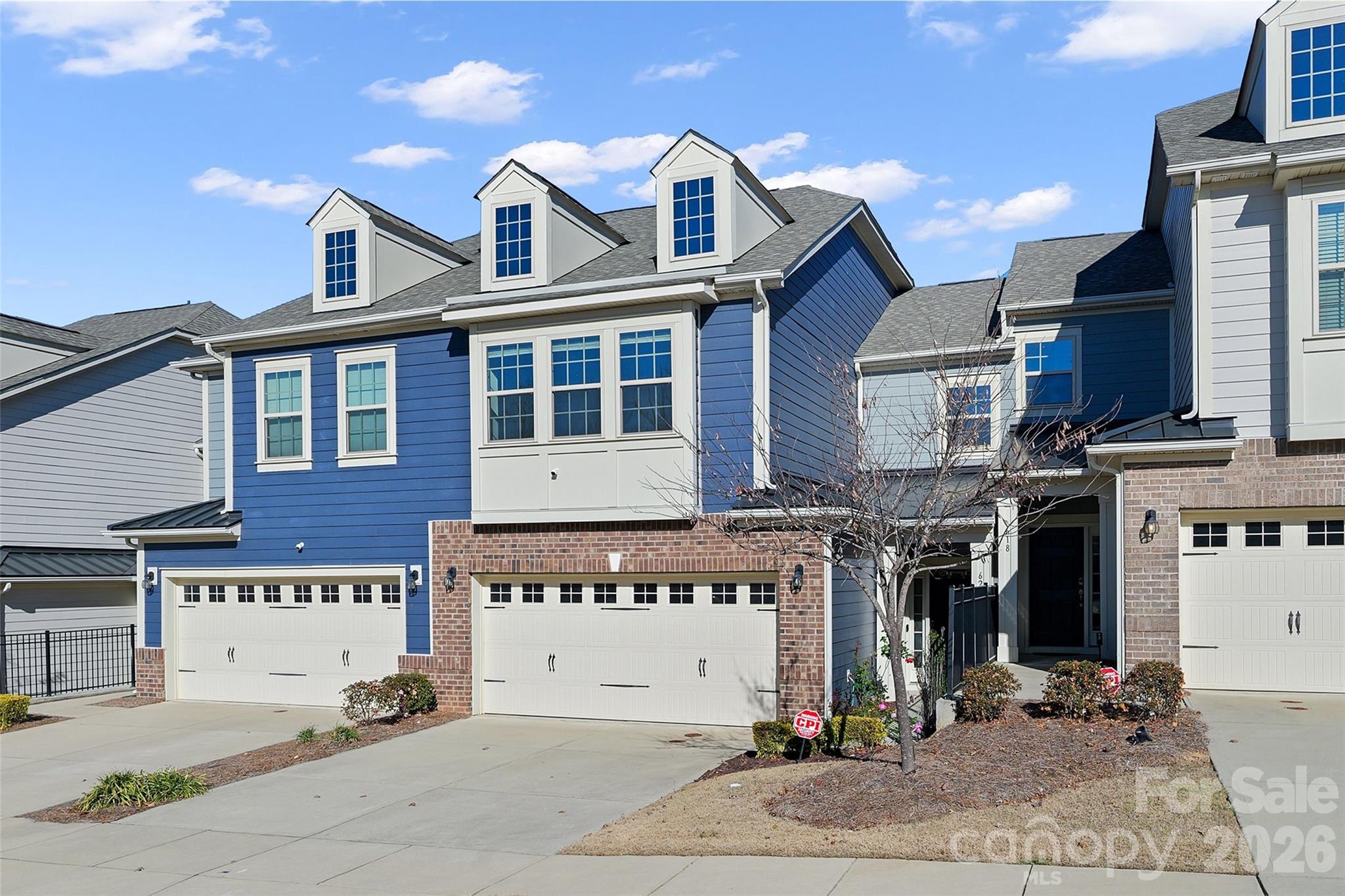 620 Amber Meadows Way Tega Cay, SC 29708 - Photo 2 of 27 a view of a white building with large windows