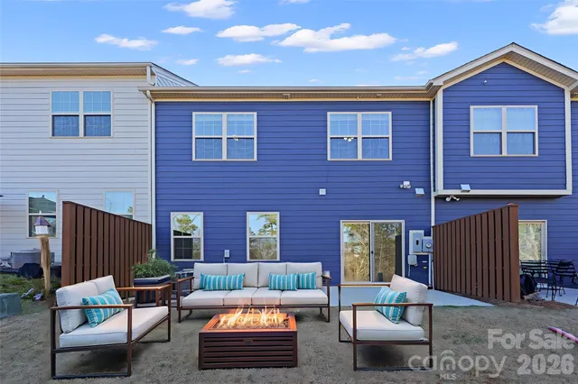 a outdoor living space with patio furniture and brick wall