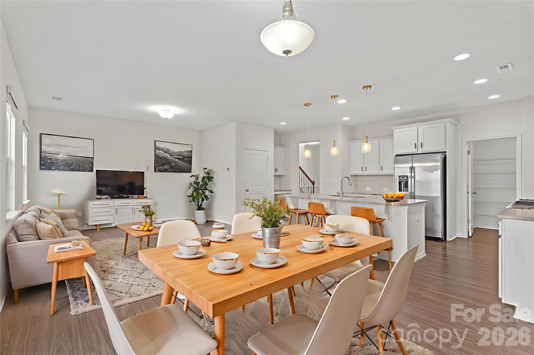 620 Amber Meadows Way Tega Cay, SC 29708 - Photo 9 of 27 a dining room with stainless steel appliances kitchen island granite countertop a table and chairs