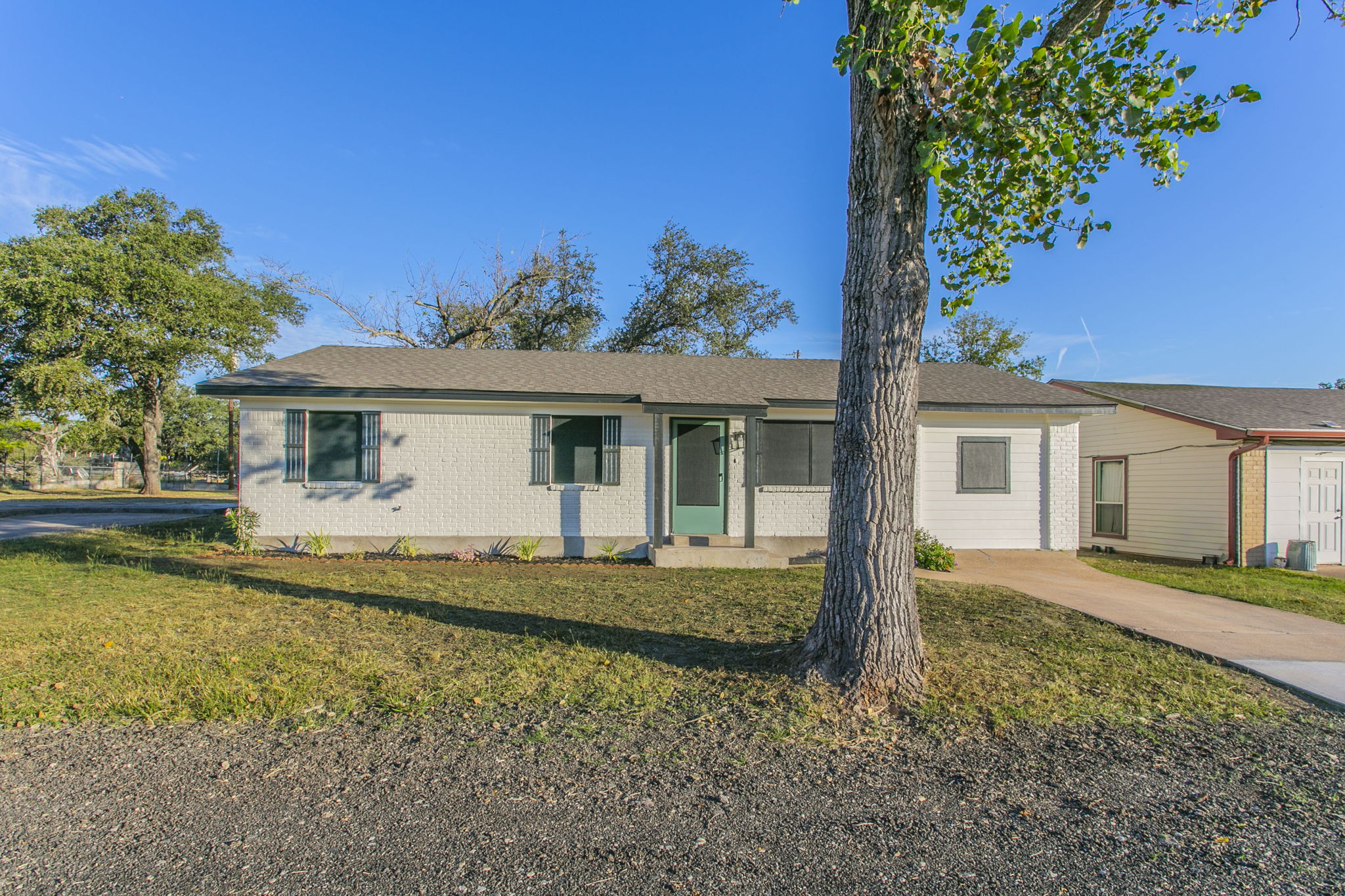 a front view of a house with a garden