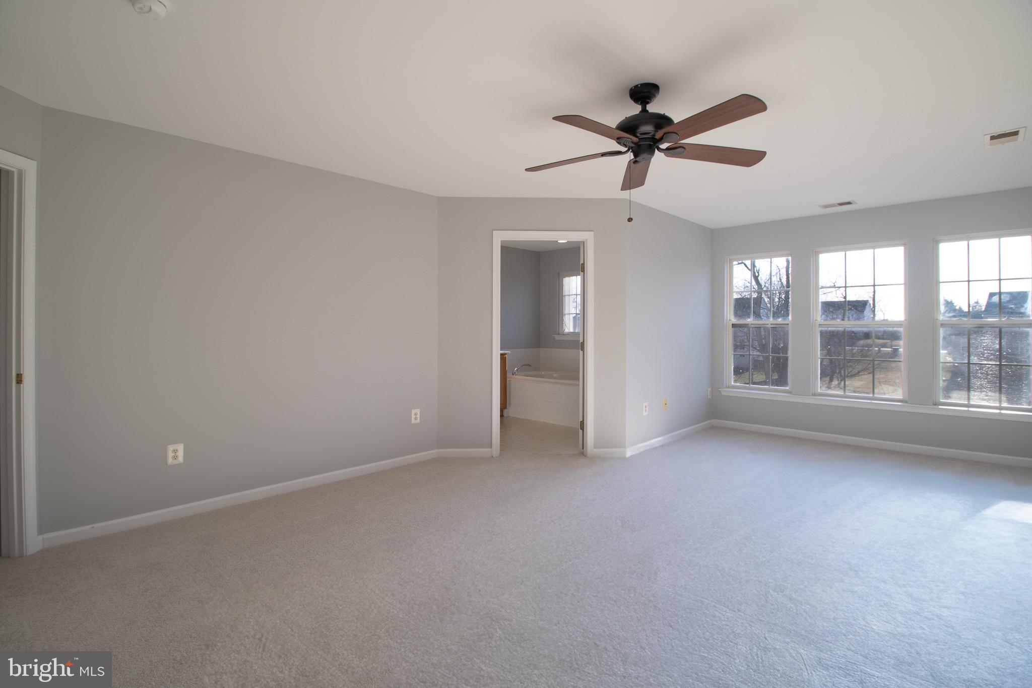 98 Lullwater Way Falling Waters, WV 25419 - Photo 21 of 43 a view of a livingroom with a ceiling fan and window