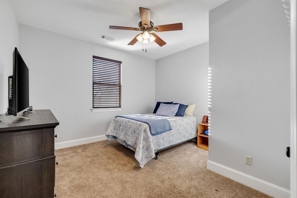 689 Jim Cannon Road Van Alstyne, TX 75495 - Photo 23 of 35 Bedroom with light carpet and ceiling fan