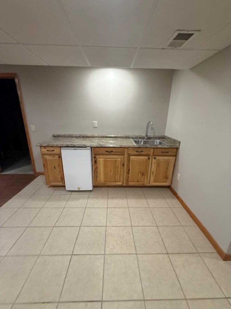 11501 Devils Creek Road Blue Grass, IA 52726 - Photo 4 of 9 a view of kitchen with granite countertop and white cabinets