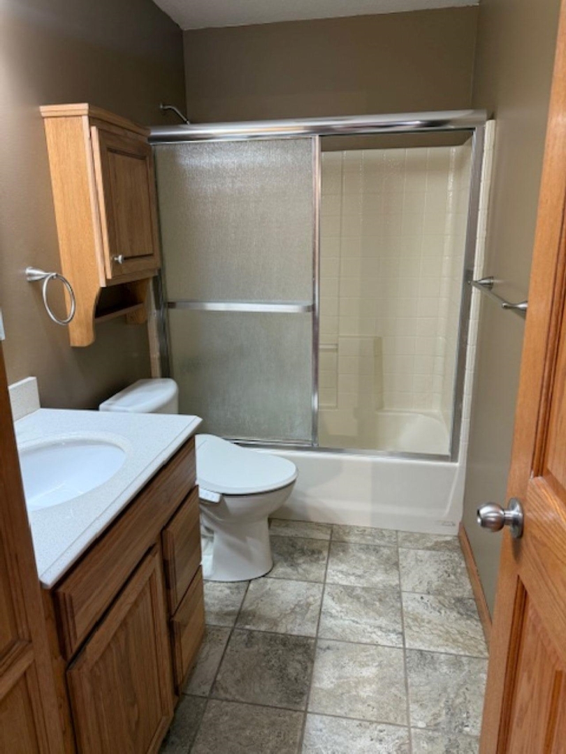 11501 Devils Creek Road Blue Grass, IA 52726 - Photo 8 of 9 a bathroom with a sink a toilet and shower