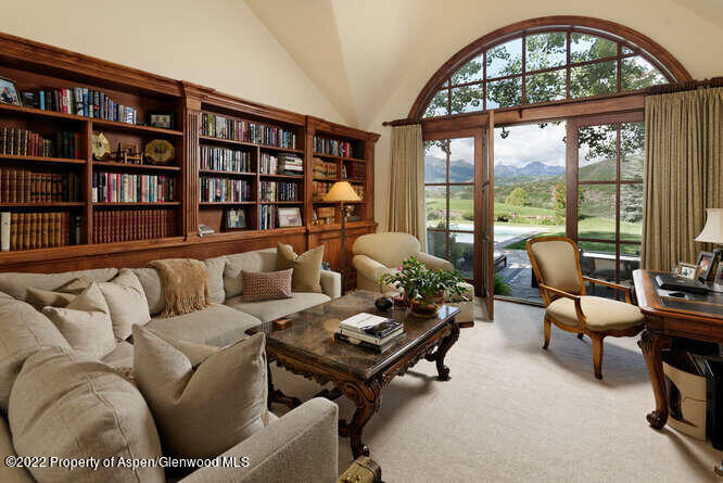 650 Pioneer Springs Ranch Road Aspen, CO 81611 - Photo 15 of 30 a living room with furniture a bookshelf and a large window