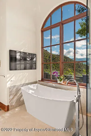 a living room with a large window and a table