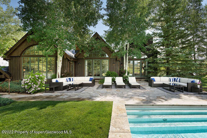 650 Pioneer Springs Ranch Road Aspen, CO 81611 - Photo 2 of 30 a view of a house with backyard sitting area and garden
