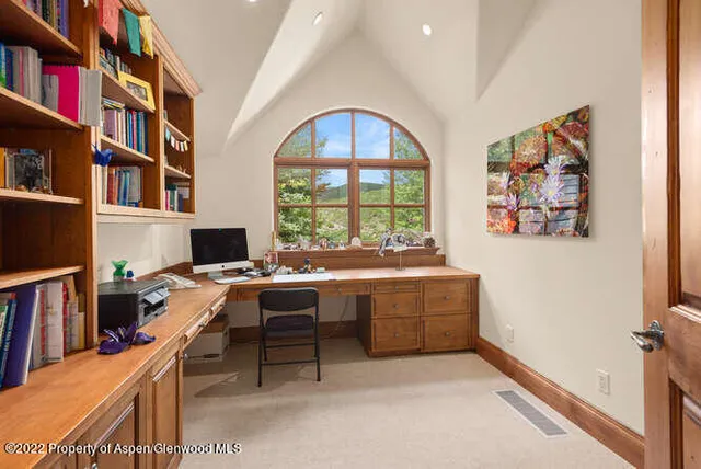 a workspace with furniture and a book shelf