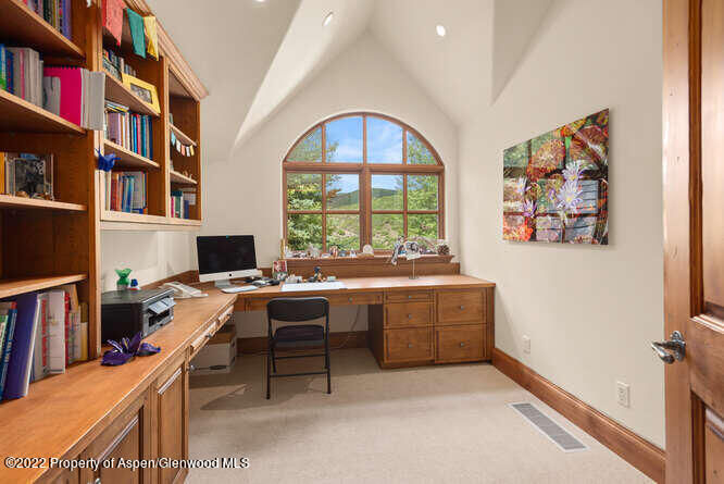 650 Pioneer Springs Ranch Road Aspen, CO 81611 - Photo 21 of 30 a workspace with furniture and a book shelf