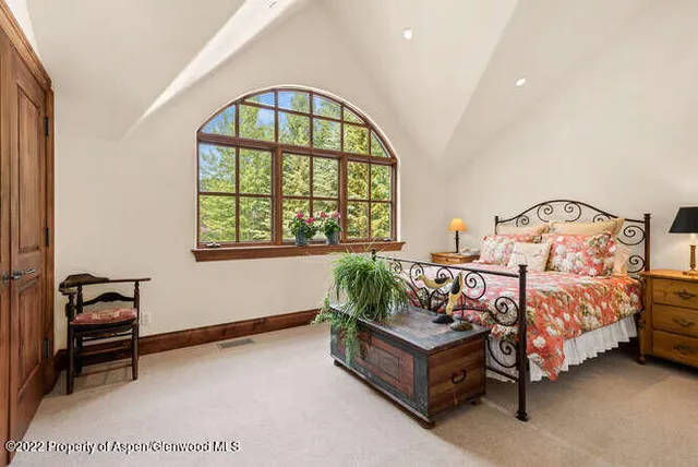 a bedroom with bed and a window