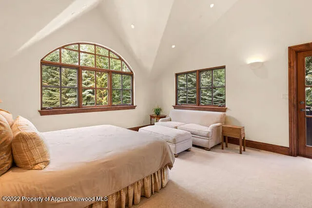 a bedroom with bed and a window