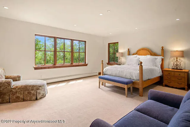 a spacious bedroom with a bed and a couch