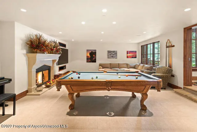 a living room with a couch a table and a fireplace