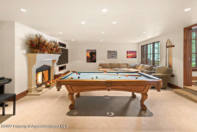 650 Pioneer Springs Ranch Road Aspen, CO 81611 - Photo 28 of 30 a living room with a couch a table and a fireplace