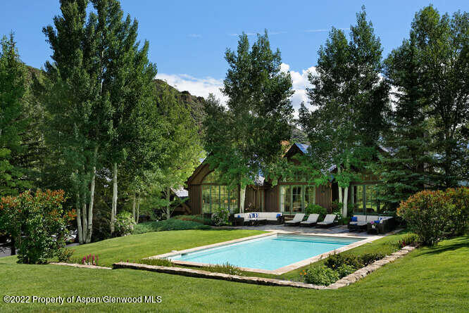 650 Pioneer Springs Ranch Road Aspen, CO 81611 - Photo 3 of 30 a view of a house with swimming pool and sitting area