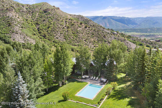 650 Pioneer Springs Ranch Road Aspen, CO 81611 - Photo 6 of 30 a view of a lush green hillside and chairs