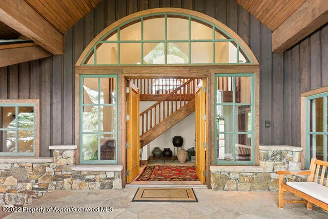 a view of an entryway with a floor to ceiling window and a mirror