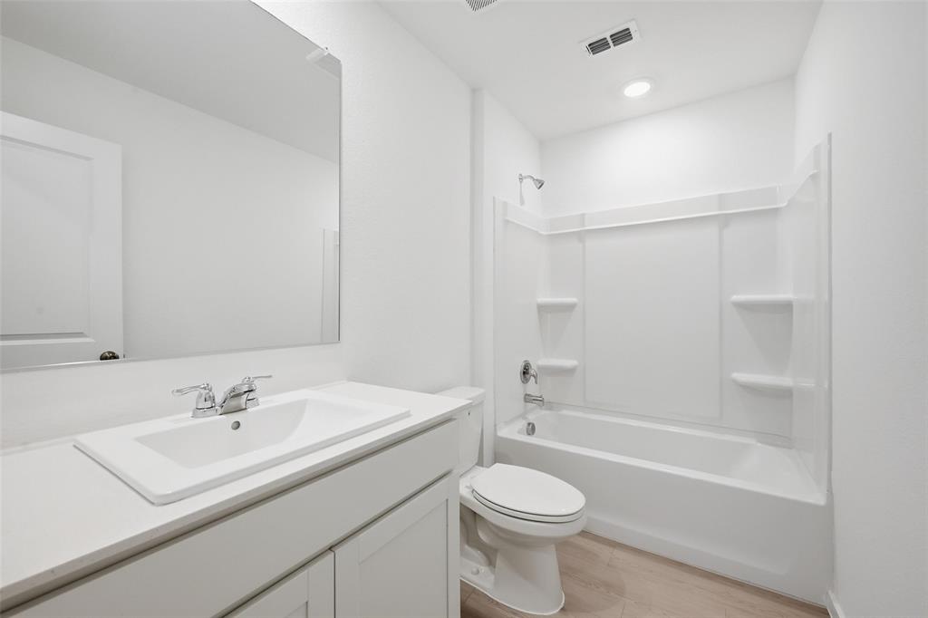 1034 Raintree Road Princeton, TX 75407 - Photo 14 of 21 a bathroom with a sink a toilet and a bathtub