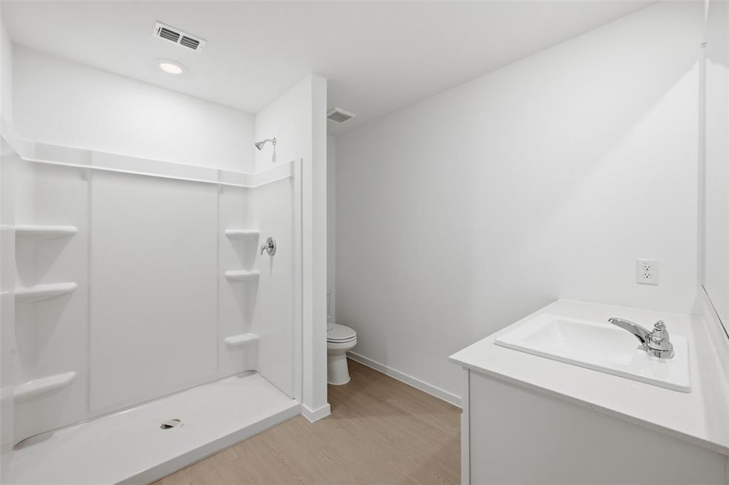 1034 Raintree Road Princeton, TX 75407 - Photo 15 of 21 a bathroom with a shower and toilet