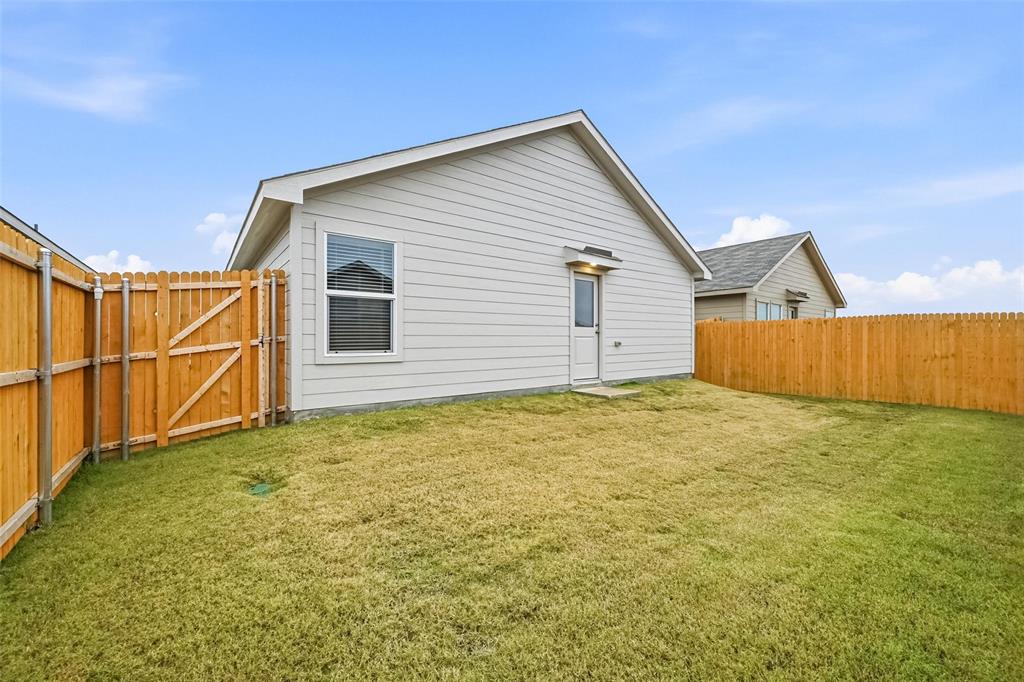 1034 Raintree Road Princeton, TX 75407 - Photo 19 of 21 a view of a house with wooden fence