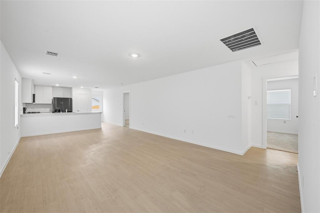 1034 Raintree Road Princeton, TX 75407 - Photo 2 of 21 a view of empty room with wooden floor