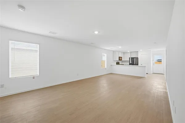 an empty room with a empty space and windows