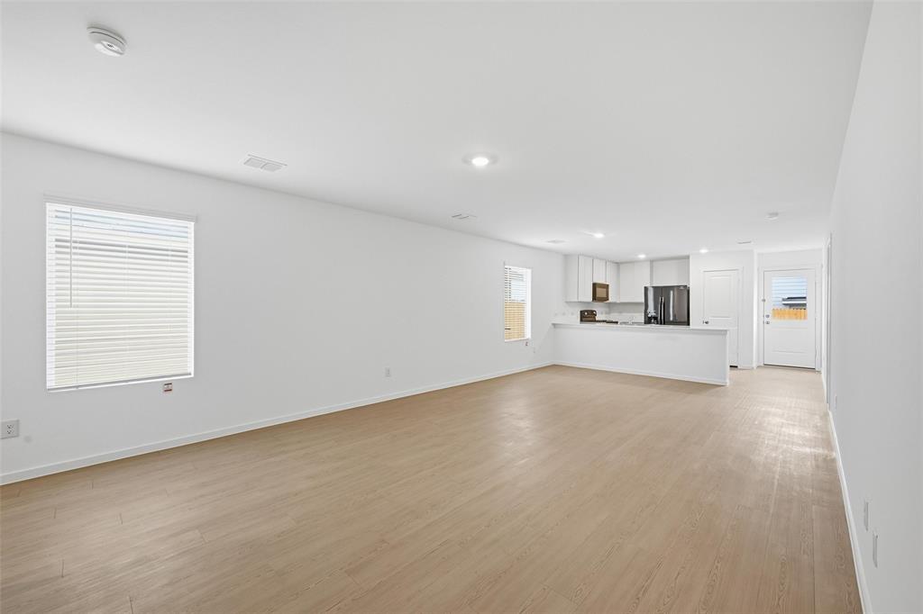 1034 Raintree Road Princeton, TX 75407 - Photo 3 of 21 an empty room with a empty space and windows