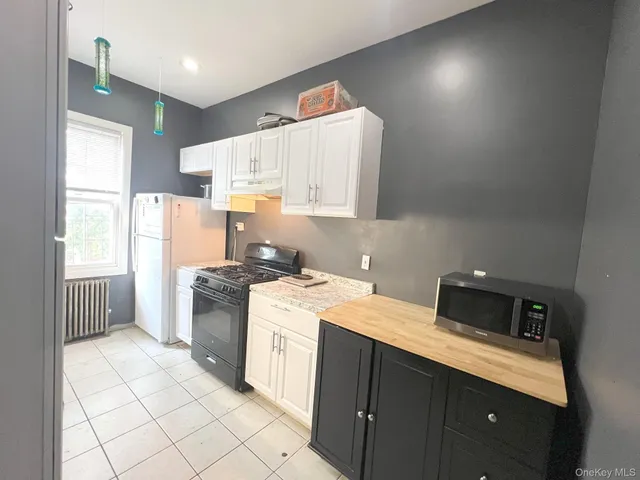 a kitchen with a sink a stove a refrigerator and cabinets