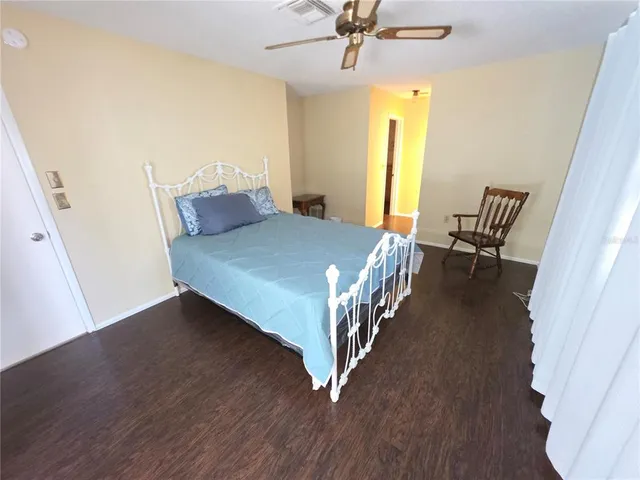 a bed sitting in a bedroom next to a window