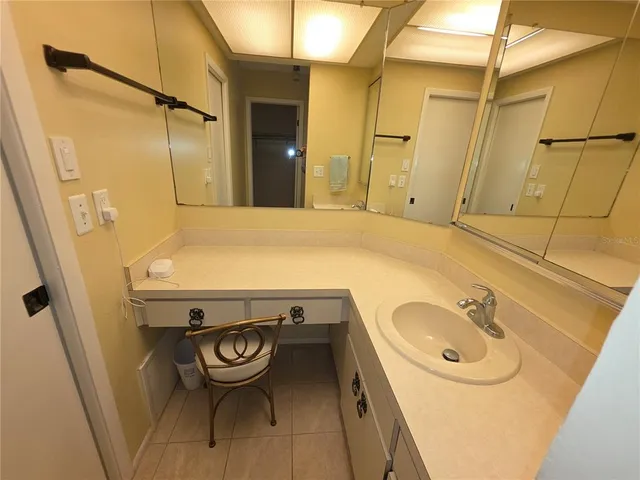 a bathroom with a sink a vanity and shower
