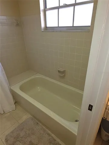 a bath tub sitting next to a window