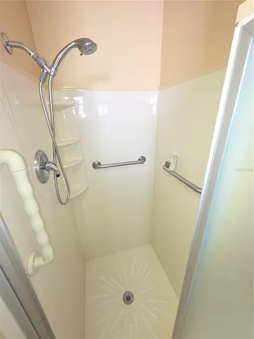 a bathroom with a glass shower door