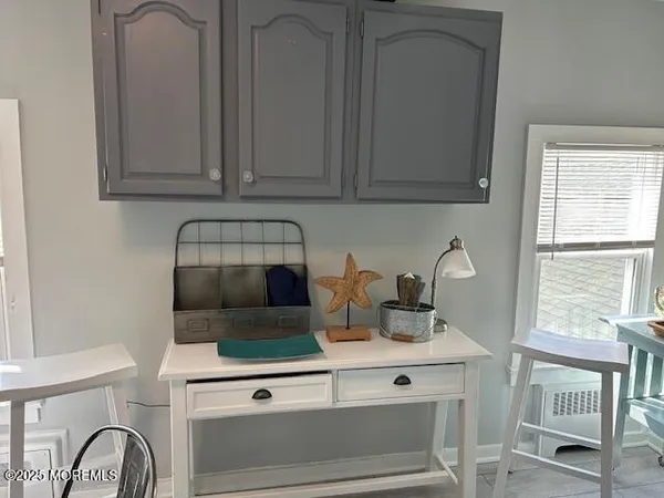 a kitchen with a stove and a white cabinets