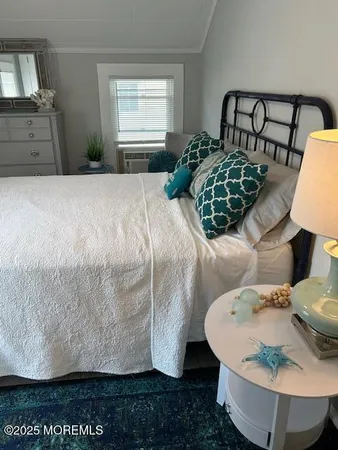 a bed sitting in a bedroom next to a window with dresser