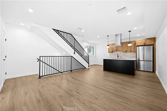 a view of a kitchen with a sink and a refrigerator