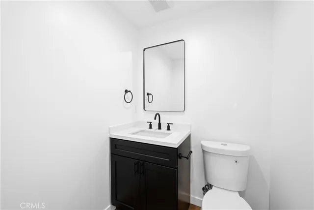 a bathroom with a sink toilet and a mirror