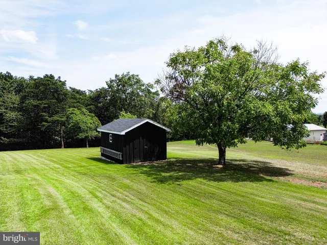 a view of a house with a garden and pathway