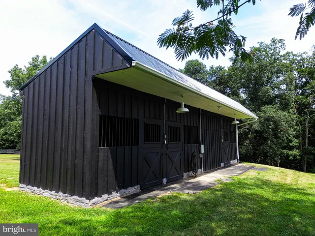 an aerial view of a house with garden space and street view
