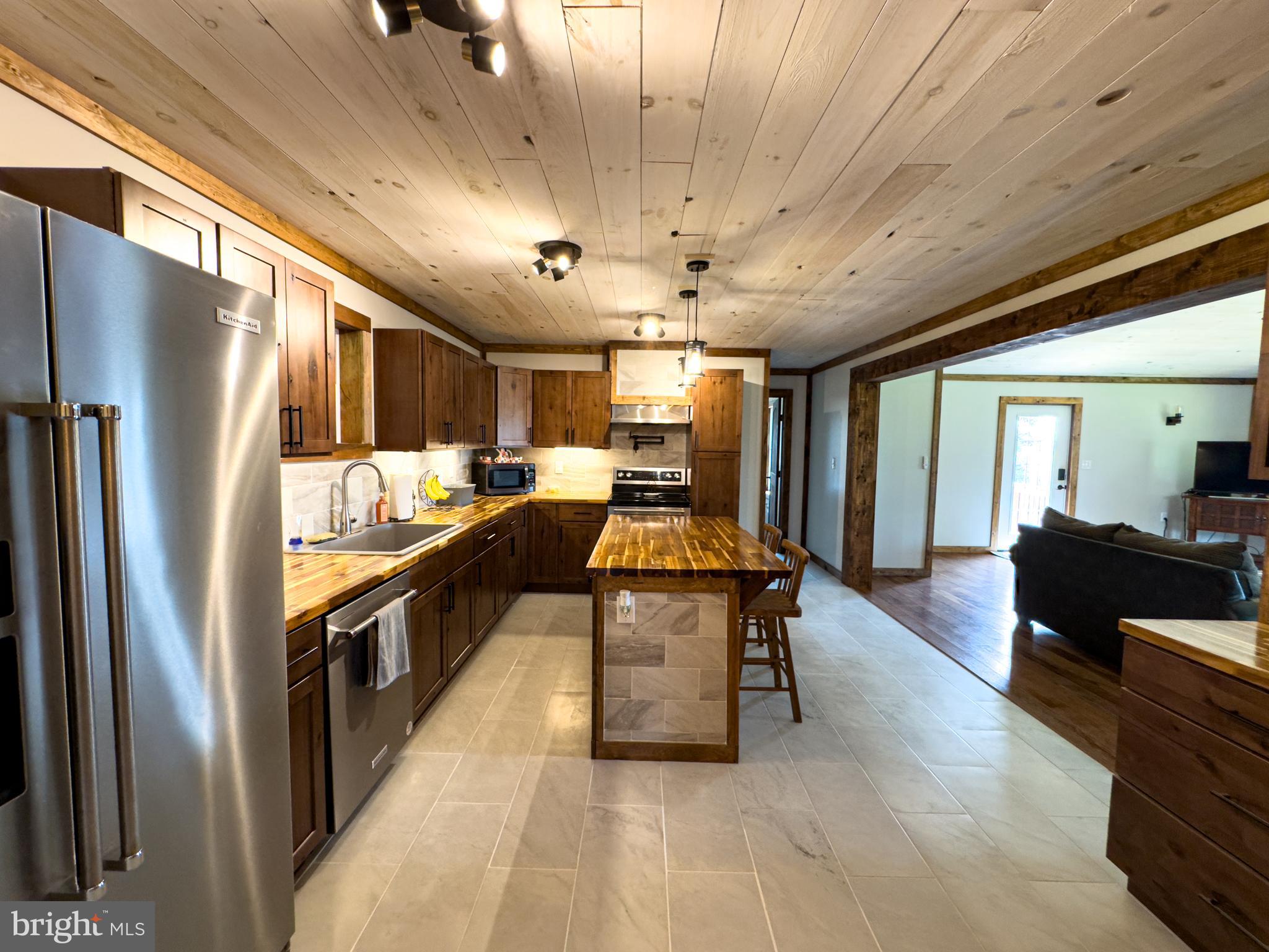 275 North Middleton Road Carlisle, PA 17013 - Photo 27 of 67 a kitchen with stainless steel appliances granite countertop a refrigerator a sink dishwasher a stove and a refrigerator with wooden floor